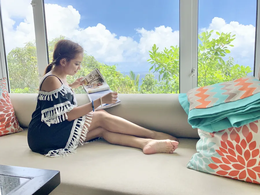 Dee relaxing on a window seat overlooking the Indian Ocean