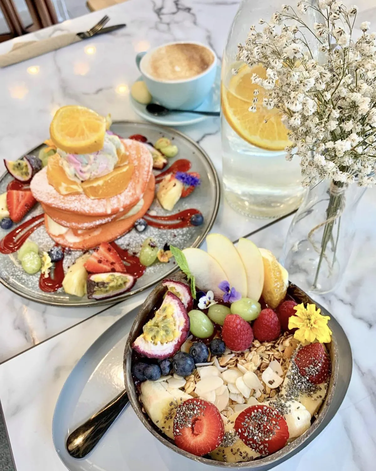 Pink pancakes and a fruit-topped smoothie bowl at brunch