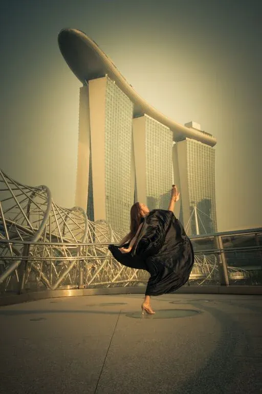 The Helix bridge and the iconic three towers of the Marina Bay Sands topped by a boat structure of the Sands Sky Park.