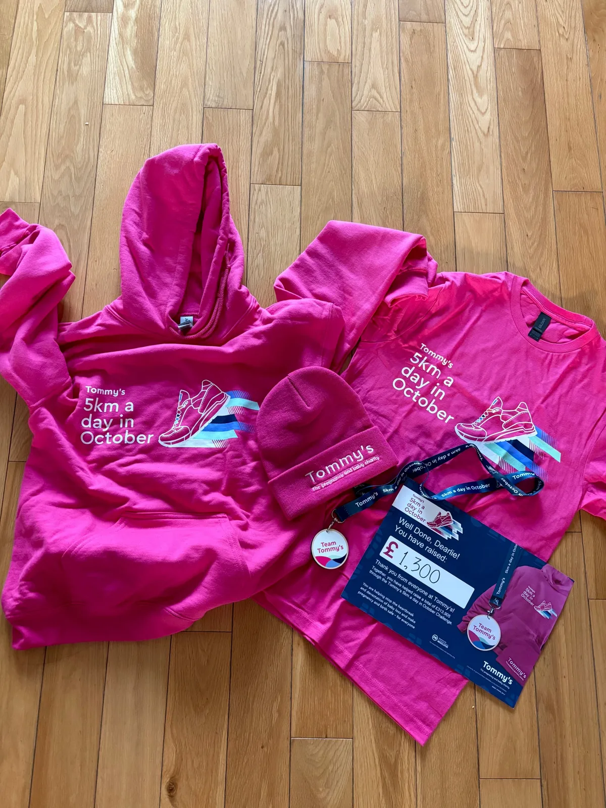 Tommy’s hoodie, T-shirt, beanie, Team Tommy’s medal and a card reading Well done, Dearlie! You have raised £1,300