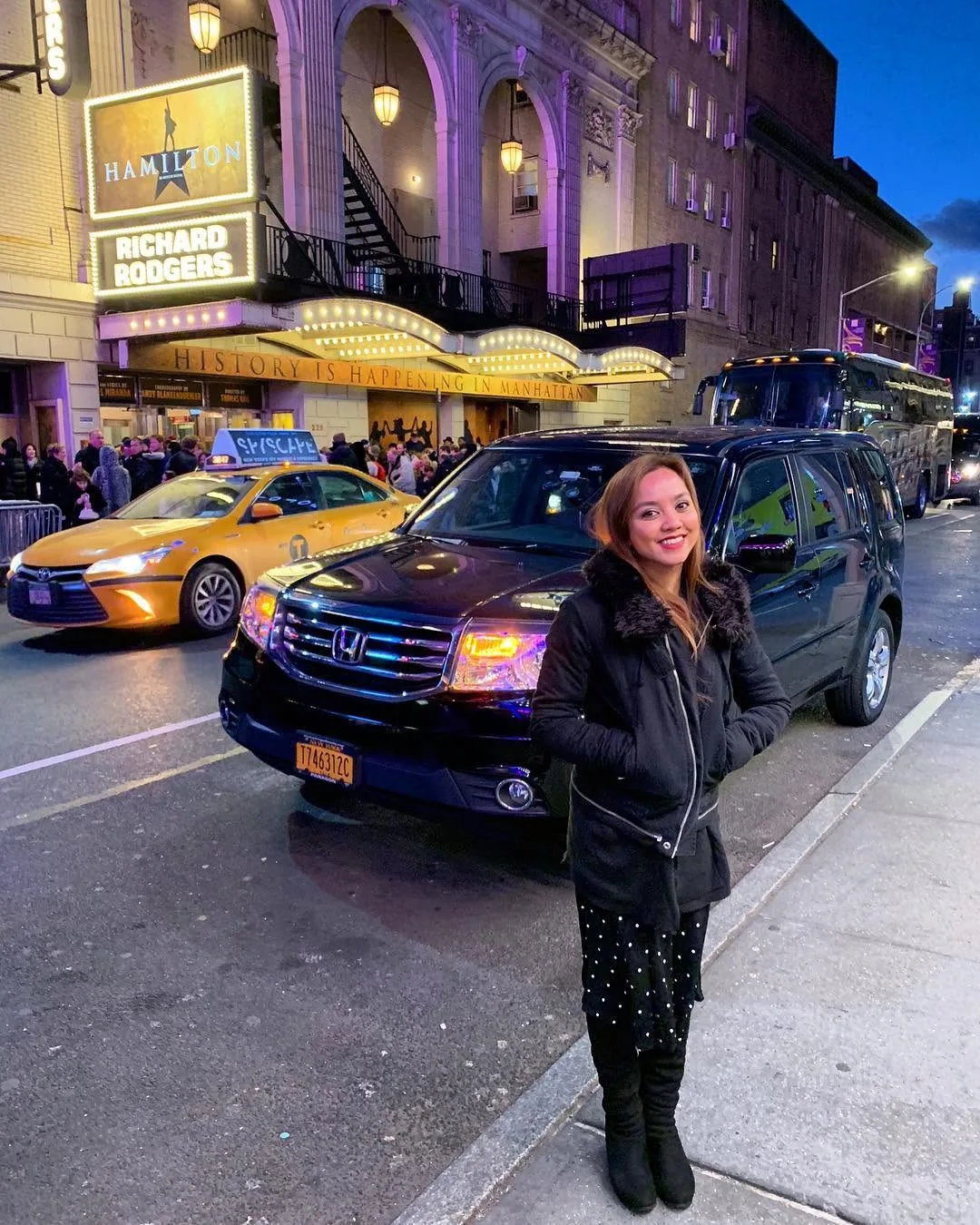 Dee outside the Richard Rodgers Theatre with the Hamilton marquee lit up
