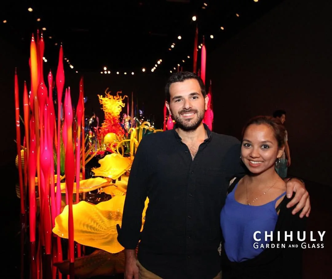 Dee and her husband among Chihuly glass sculptures