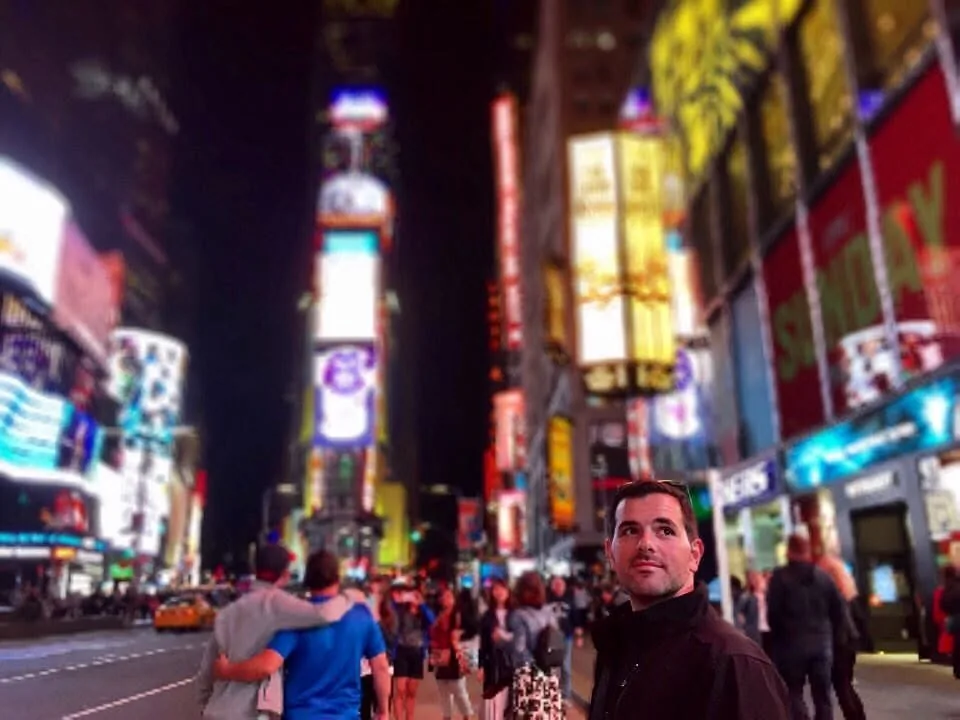 Dee’s husband looking up at the lights of Times Square