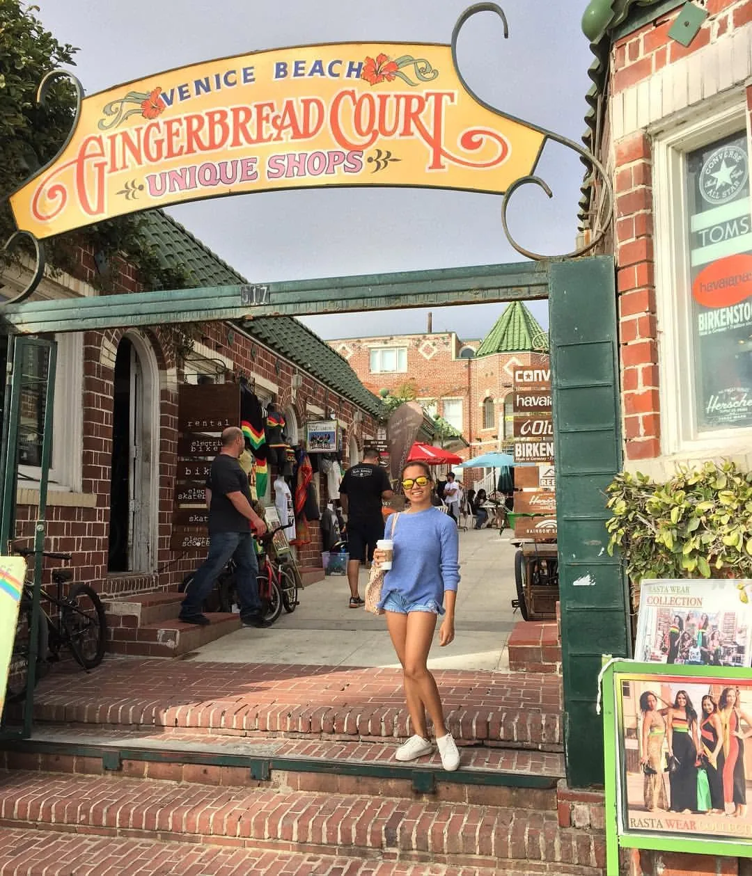 Dee under the Gingerbread Court sign at Venice Beach